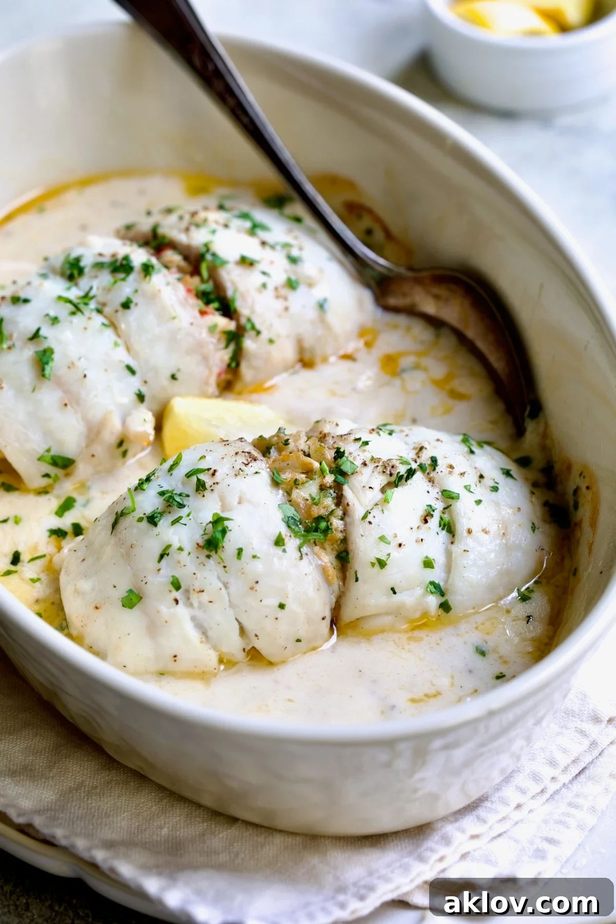 Two beautifully plated servings of Crab-Stuffed Flounder in an oval baking dish after baking, ready to be served.