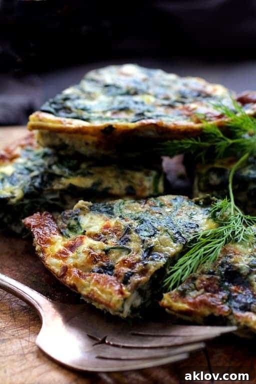 Mediterranean Greens and Feta Frittata 6 Photo of pieces of frittata piled up on wood trivet. Generous slices of Spinach Leek and Feta Cheese Frittata arranged on a wooden trivet, inviting diners to enjoy this wholesome meal.
