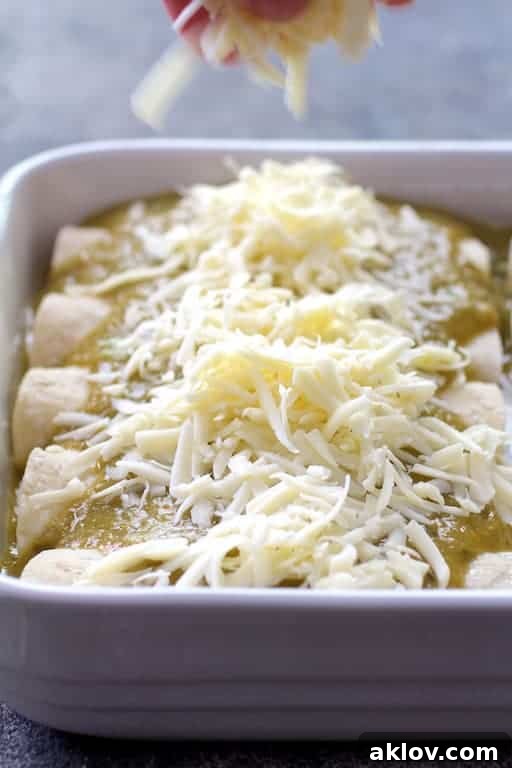 Photo of cheese being sprinkled over enchiladas.