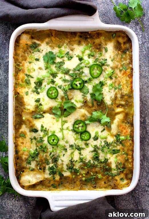 Lima Bean and Potato Enchiladas with Hatch Green Chile Sauce in white rectangular baking dish.