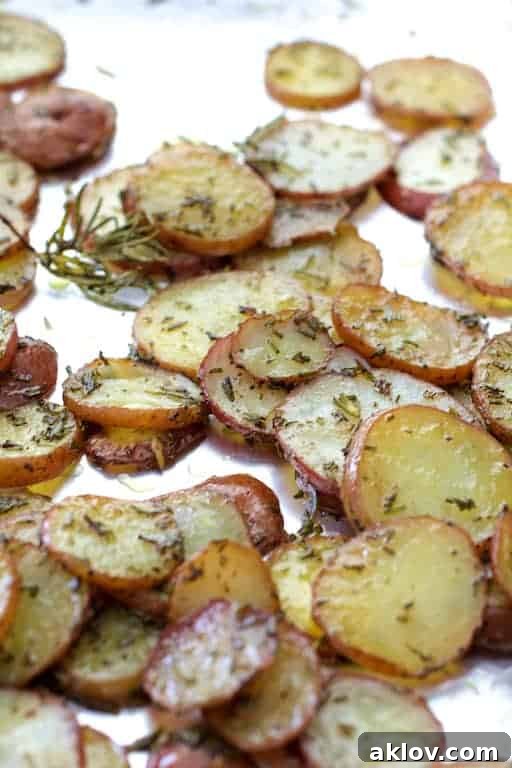 Perfectly roasted thinly sliced potatoes with fragrant rosemary, tender and creamy.