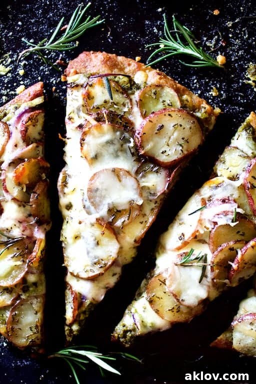A single, delectable slice of Naan Potato Pizza with Radish Pesto and Smoked Mozzarella, highlighting the vibrant toppings.