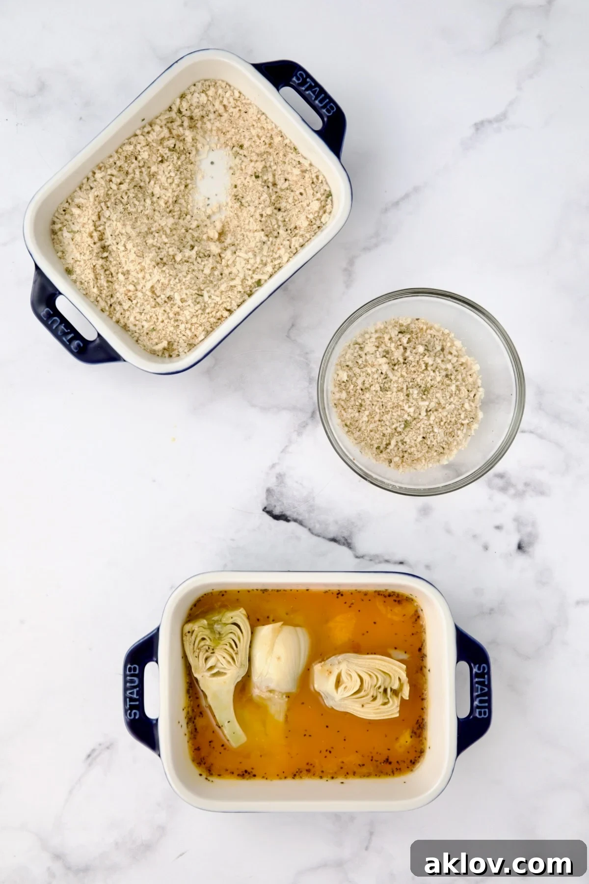 Three containers with breadcrumbs in two, and eggs in a third.
