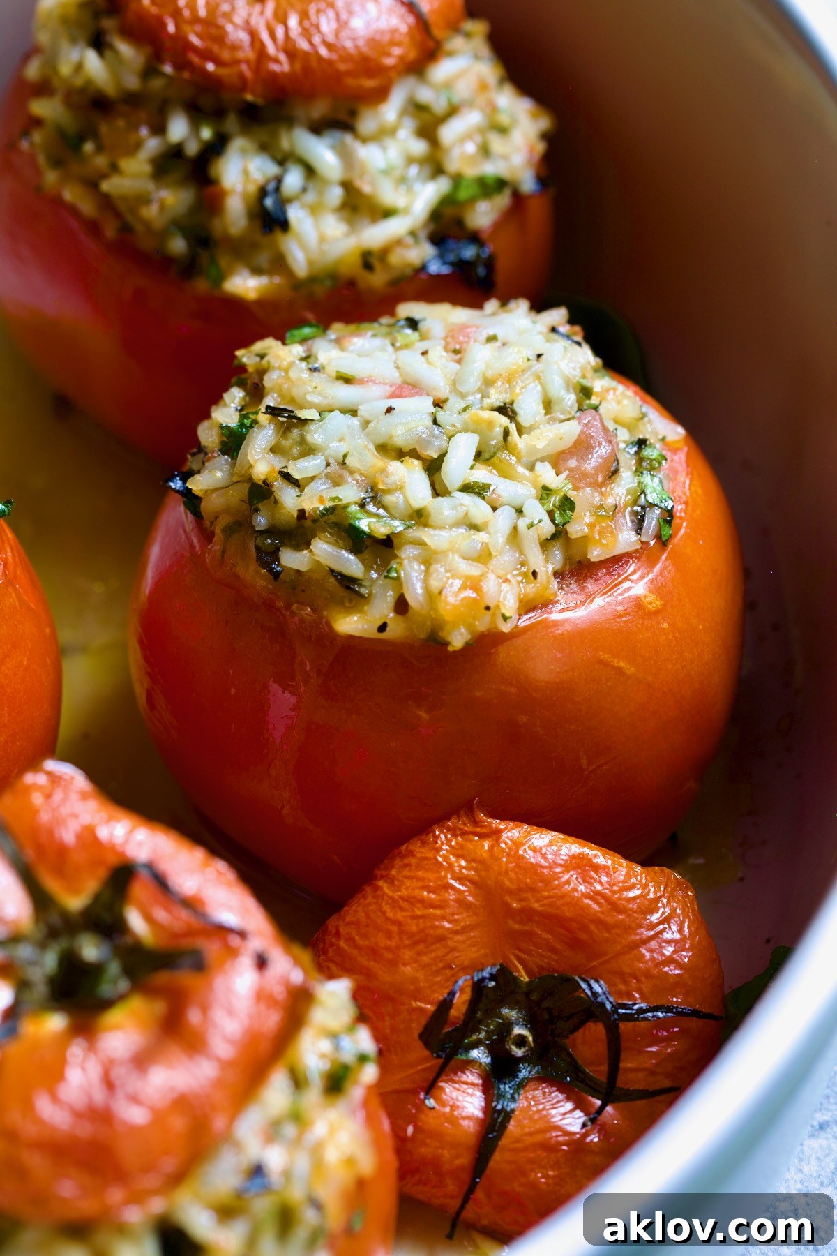 Close-up of one of the Cheesy Rice Stuffed Tomatoes with the top removed to expose the delicious, cheesy filling.