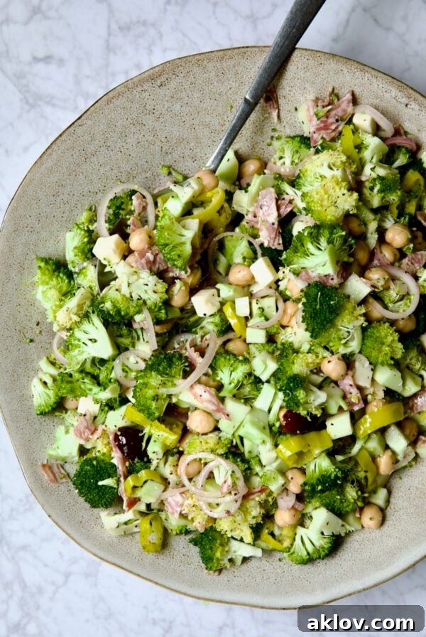 Italian Broccoli Salad in earthenware bowl with serving fork.
