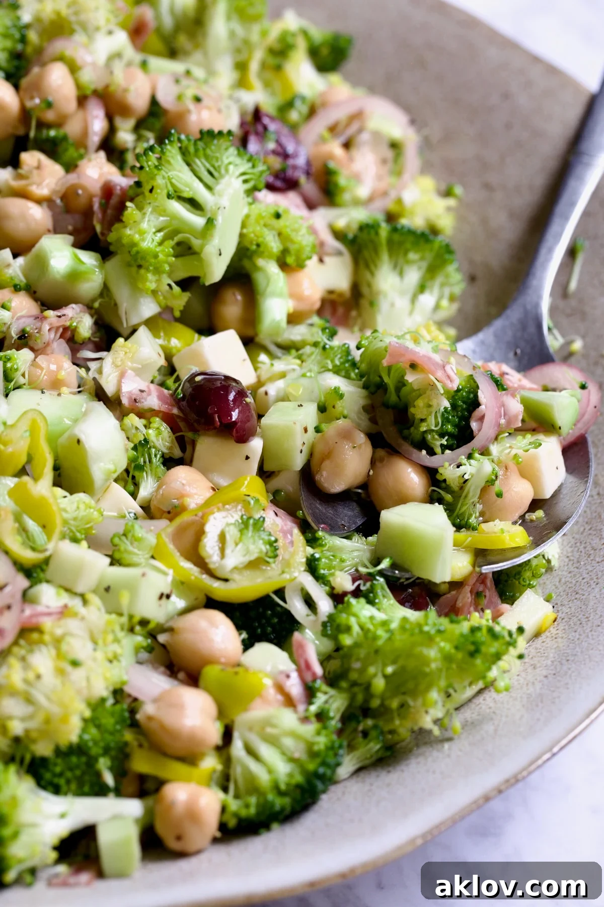 Italian Broccoli Salad in earthenware bowl with serving fork.