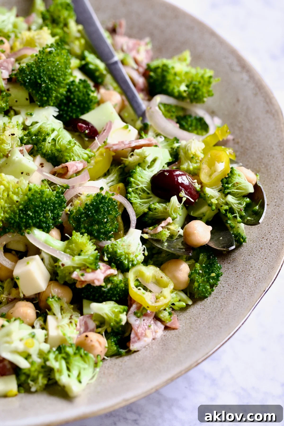 Italian Broccoli Salad in earthenware bowl with serving fork.