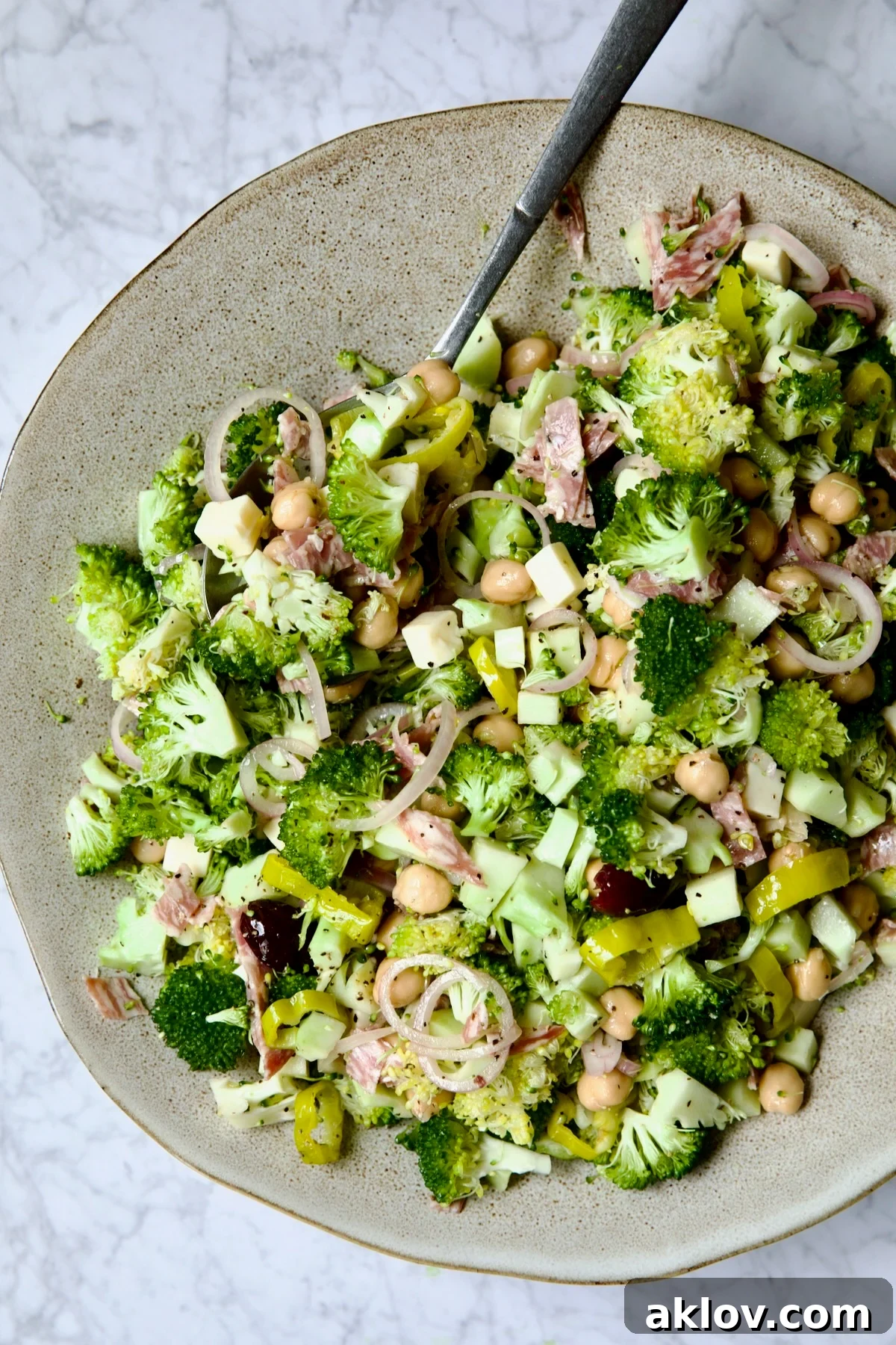 Italian Broccoli Salad in earthenware bowl with serving fork.