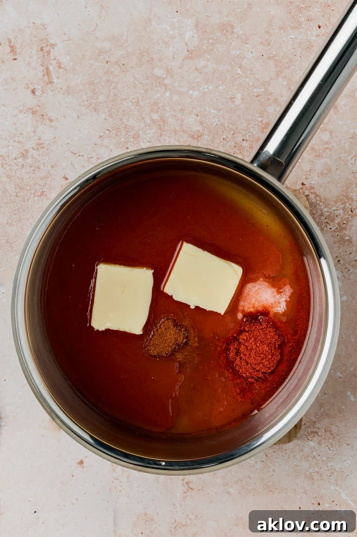 Sauce ingredients in stainless steel saucepan before being cooked.