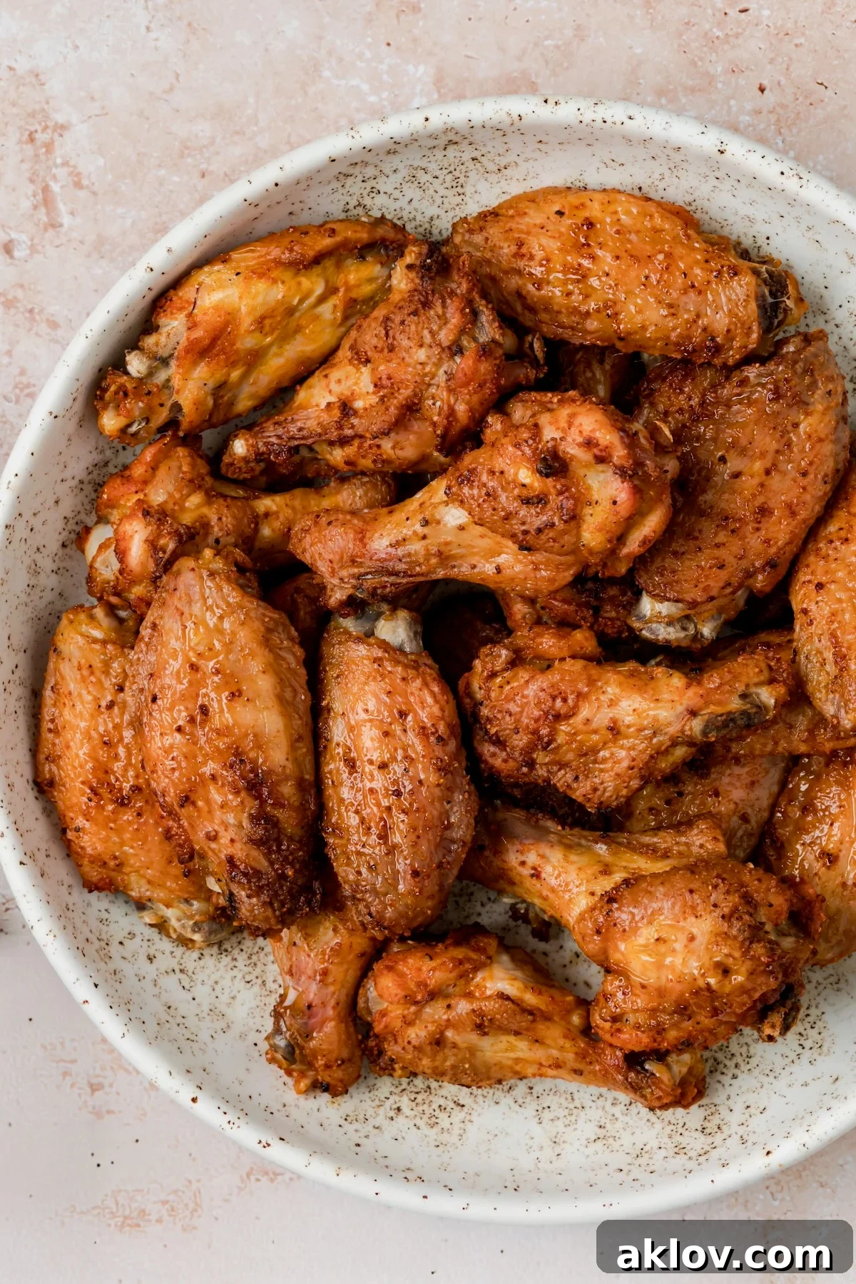 Baked wings in bowl before sauce is added.