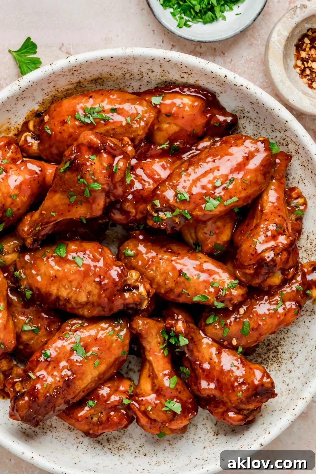 Glazed Hot Honey Chicken Wings in speckled bowl.