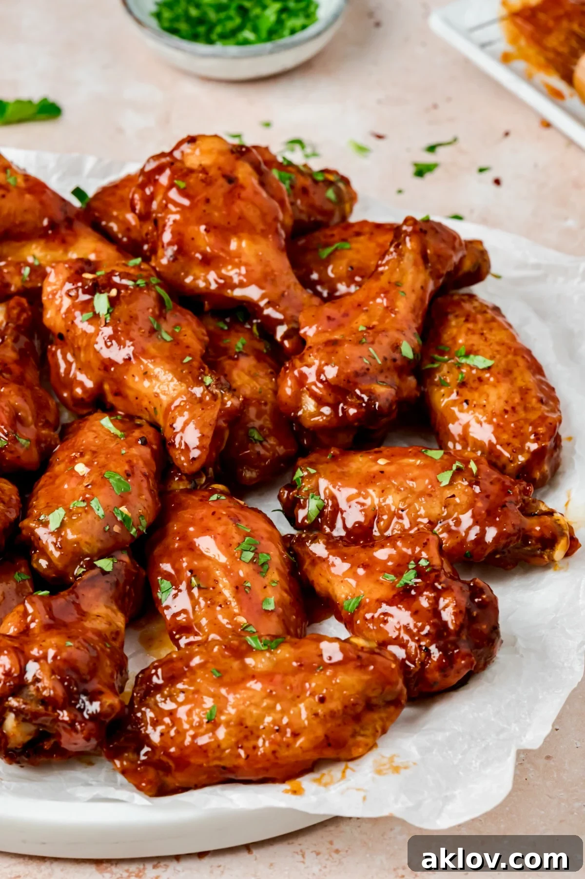 Hot Honey Chicken Wings on parchment paper lined platter.