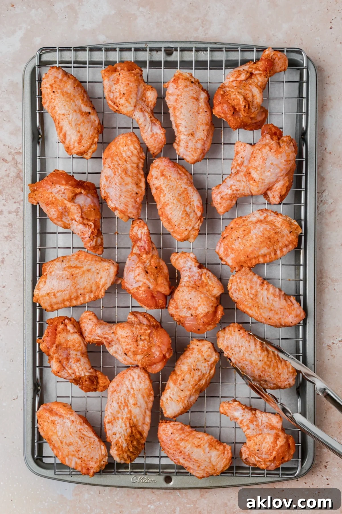 Wings on rack-lined rimmed baking sheet before being baked.