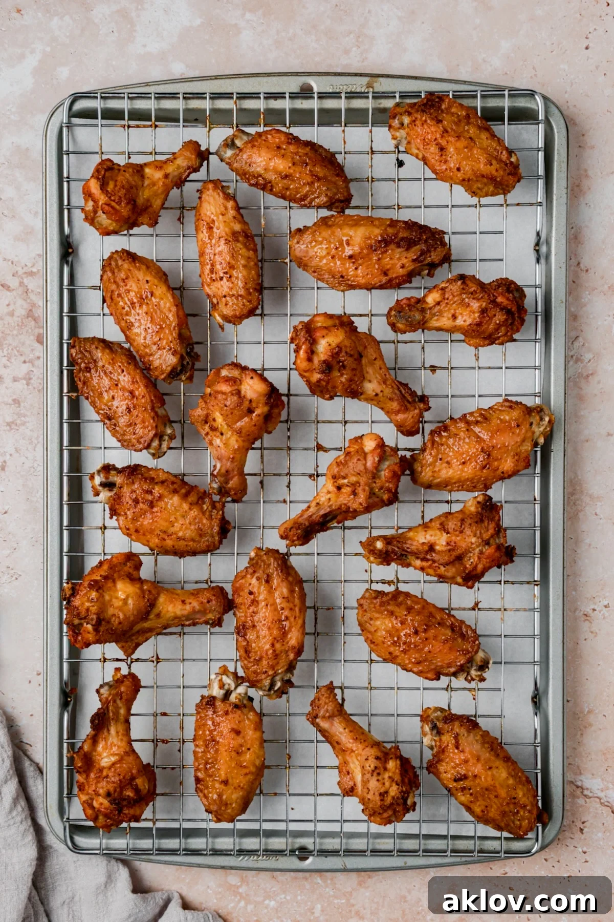 Wings on rack-lined rimmed baking sheet after being baked.