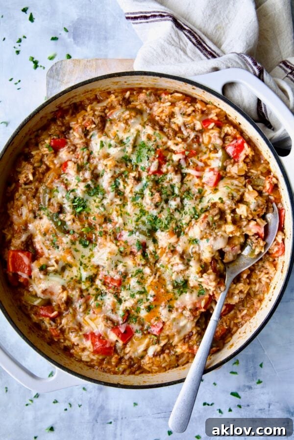 Unstuffed Peppers Skillet, a family-friendly one-pan meal, served in a white enamel cast iron skillet.