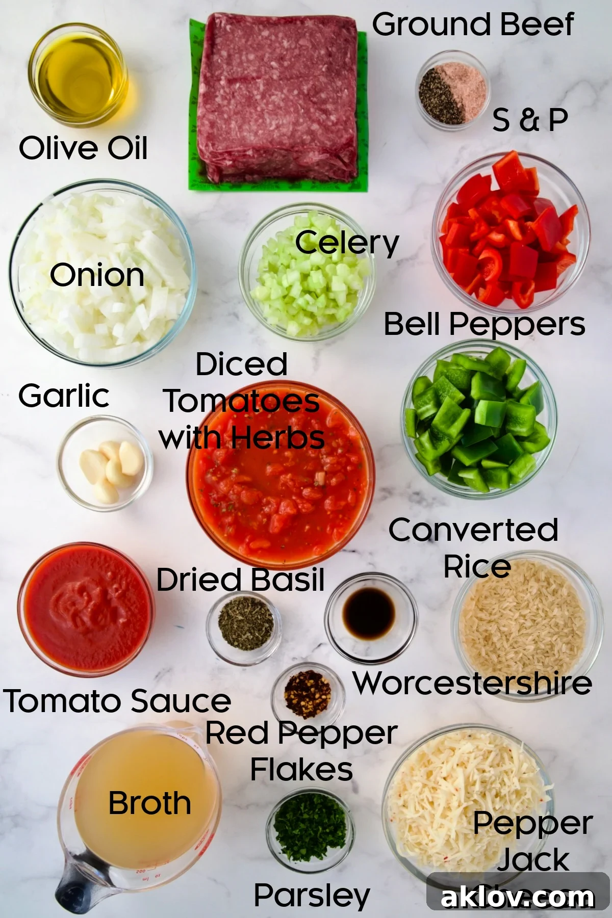 Collection of fresh ingredients for Unstuffed Peppers Skillet, including bell peppers, ground beef, rice, and cheese, displayed in glass bowls.