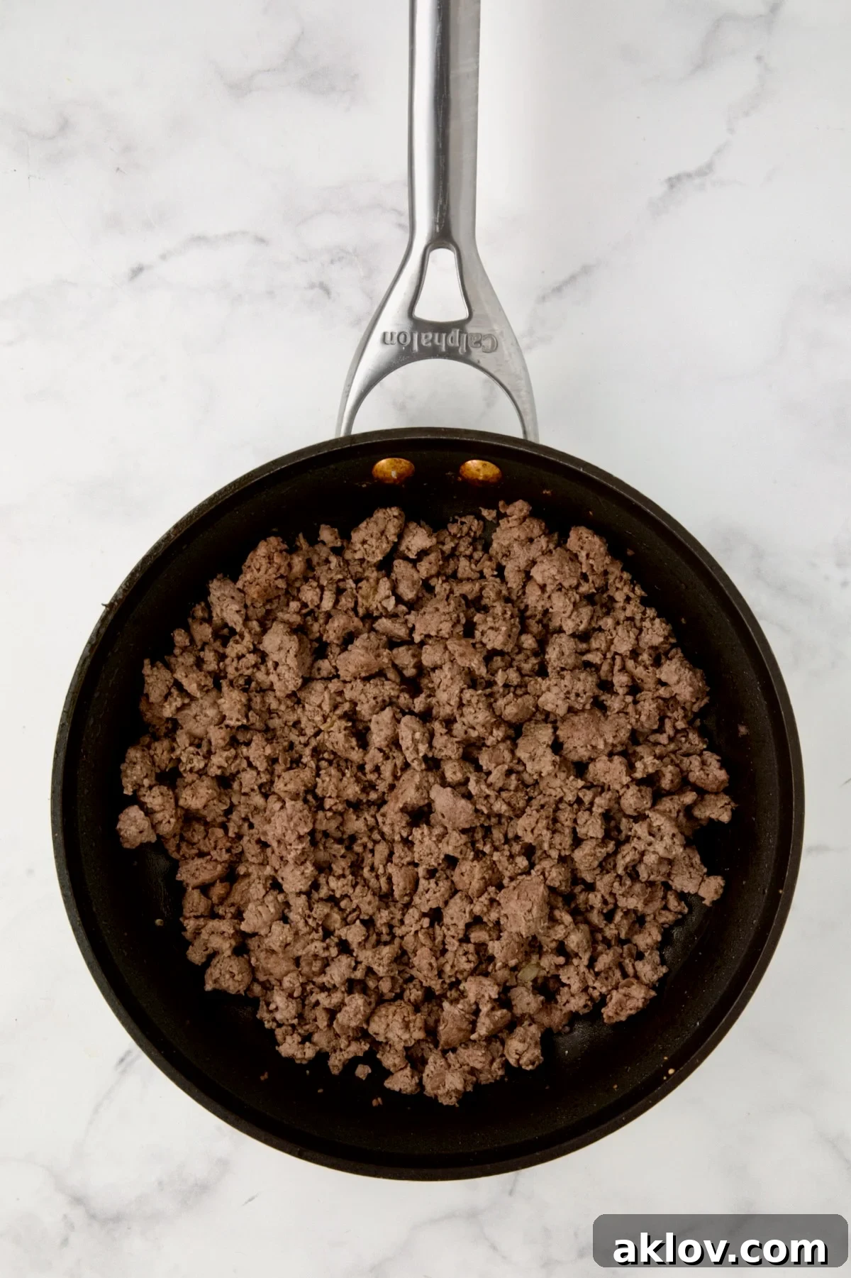 Cooked ground beef in nonstick skillet.