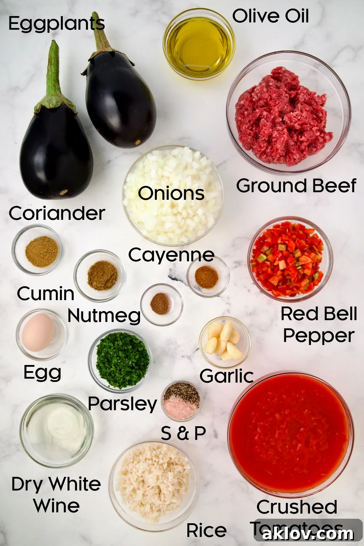 Ingredients for Stuffed Eggplant in glass bowls.
