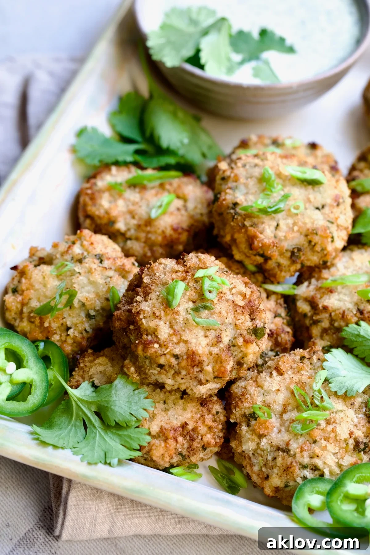 Stacked Thai Green Curry Shrimp Cakes garnished with cilantro leaves.