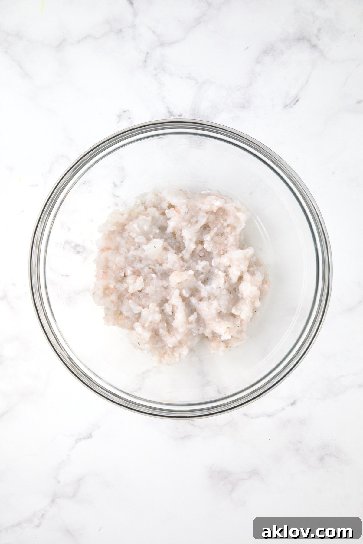 Chopped shrimp in glass bowl.