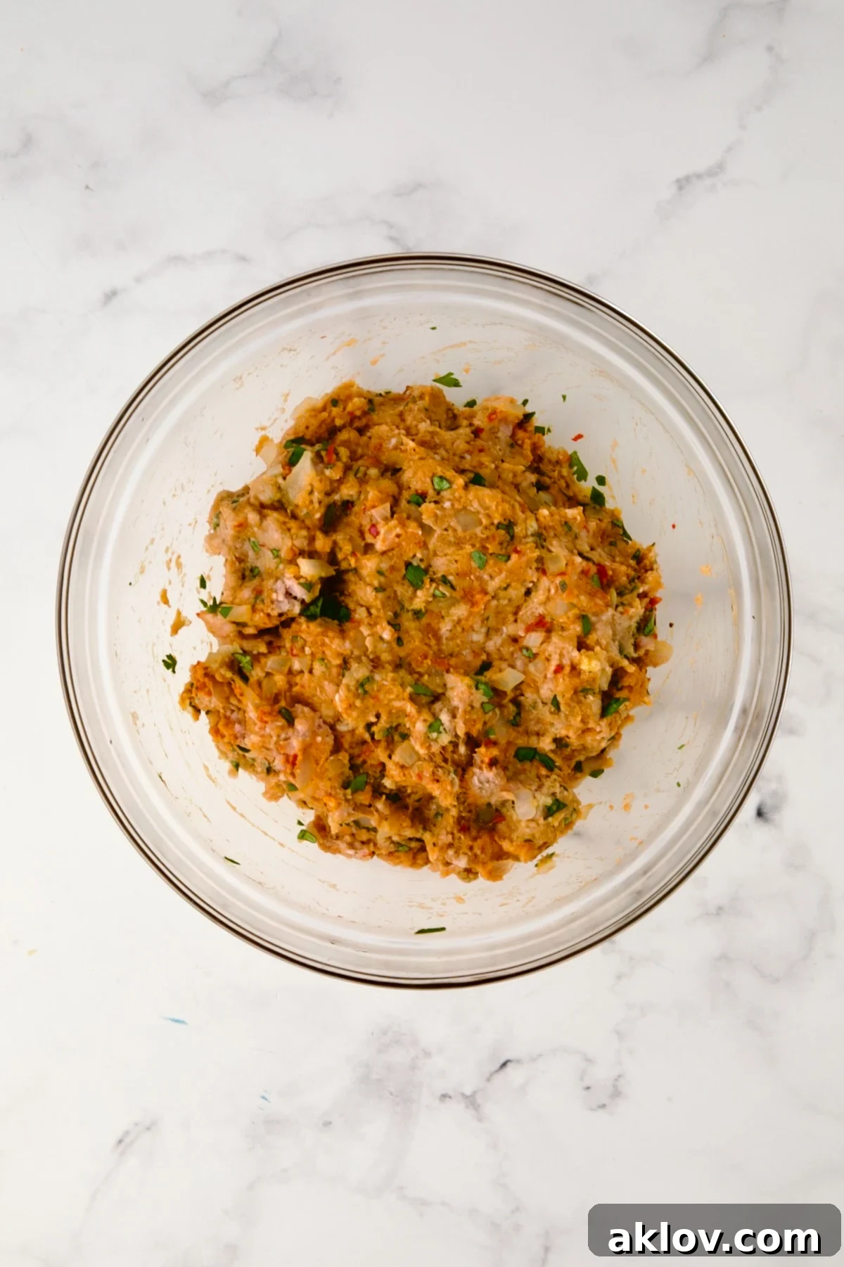 The meatball mixture after being gently combined in the bowl.