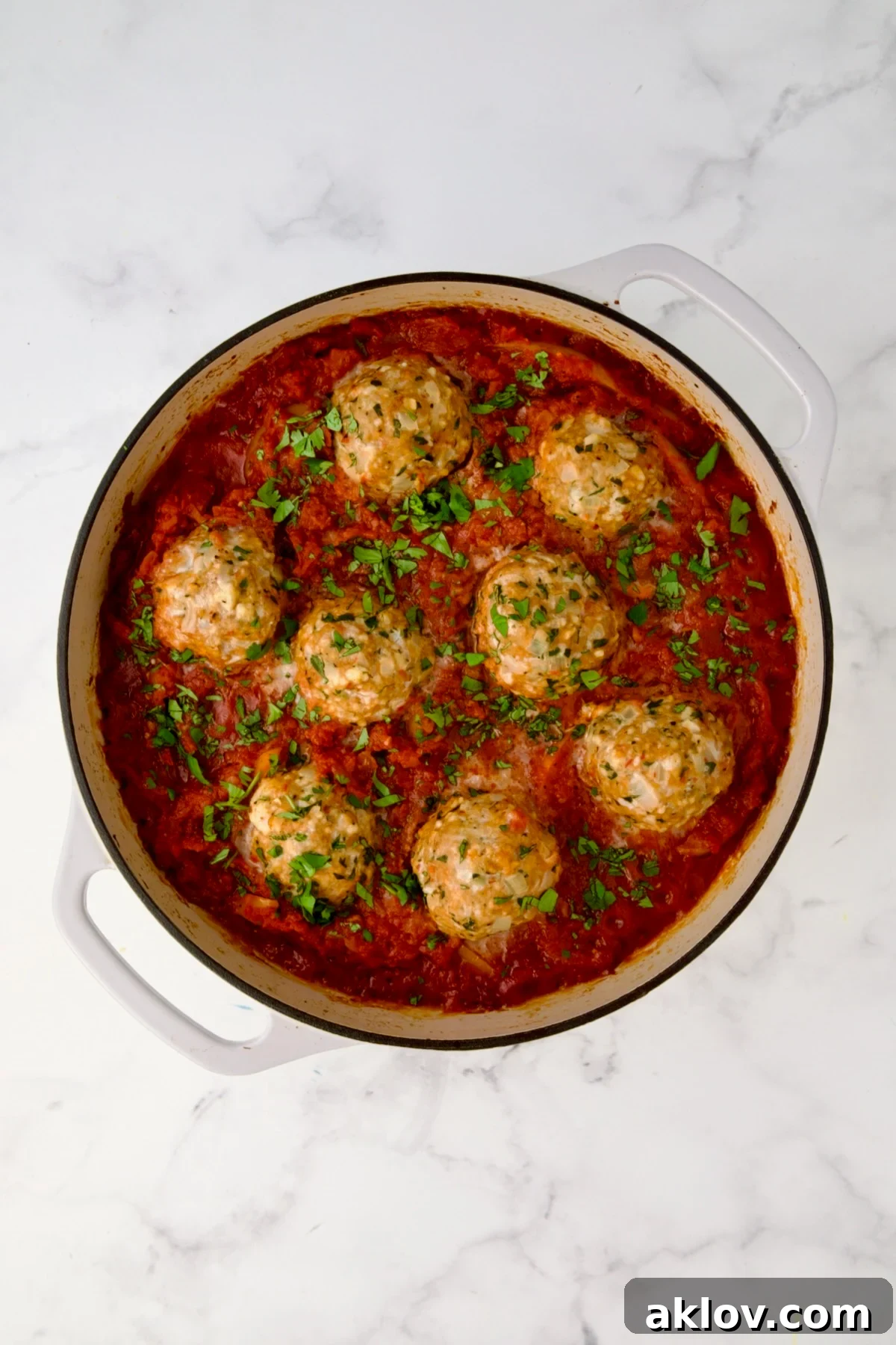 The fully cooked Harissa Chicken Meatballs in the skillet after baking.