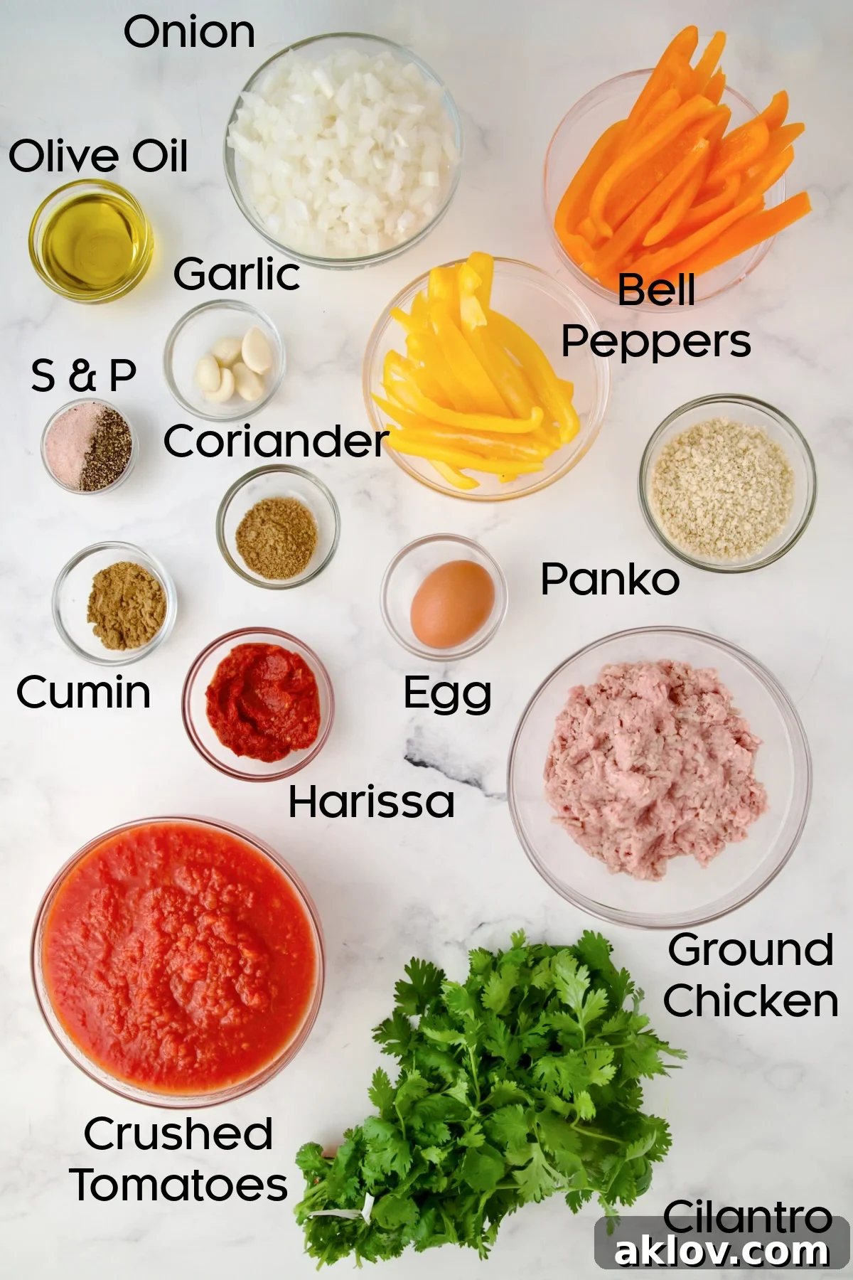 Ingredients for Harissa Chicken Meatballs laid out in bowls on a countertop.