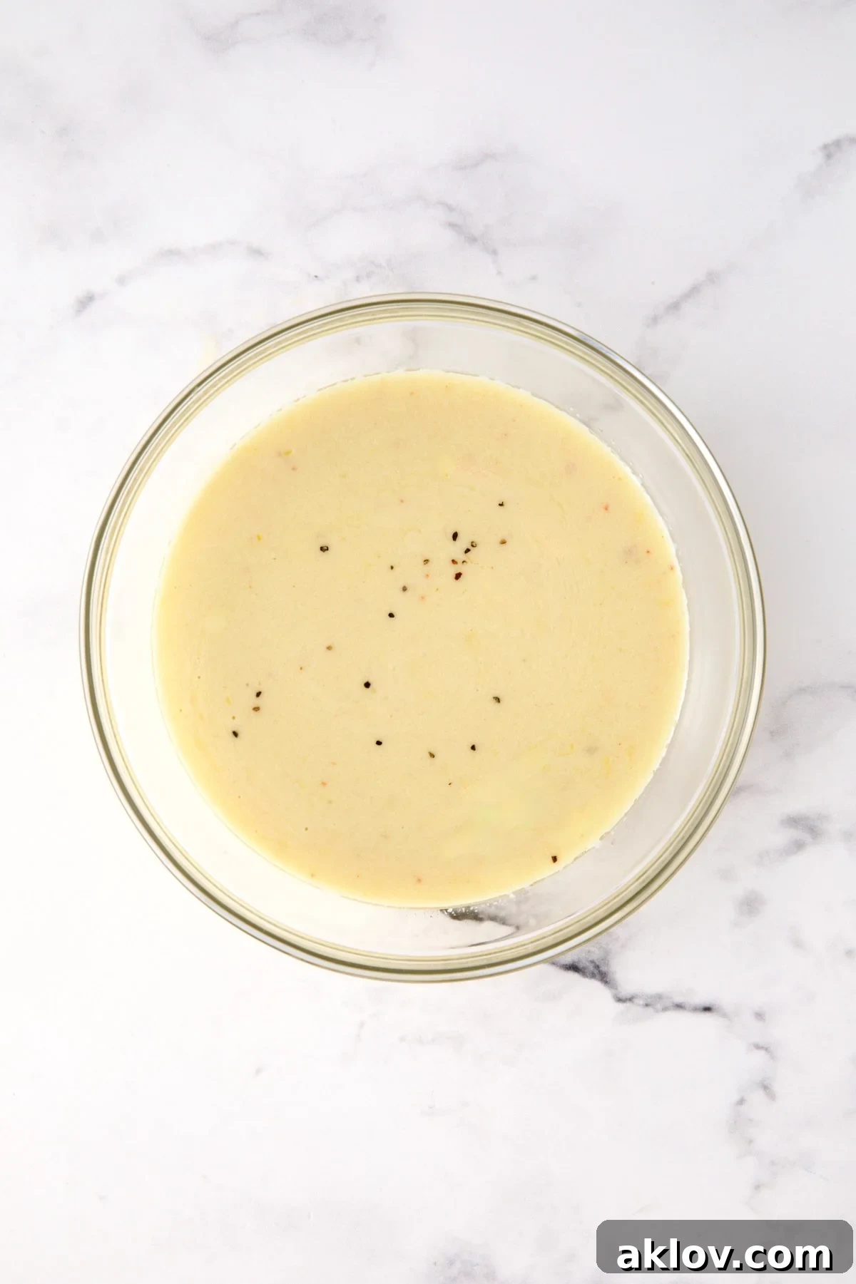 Lemon salad dressing in glass bowl.