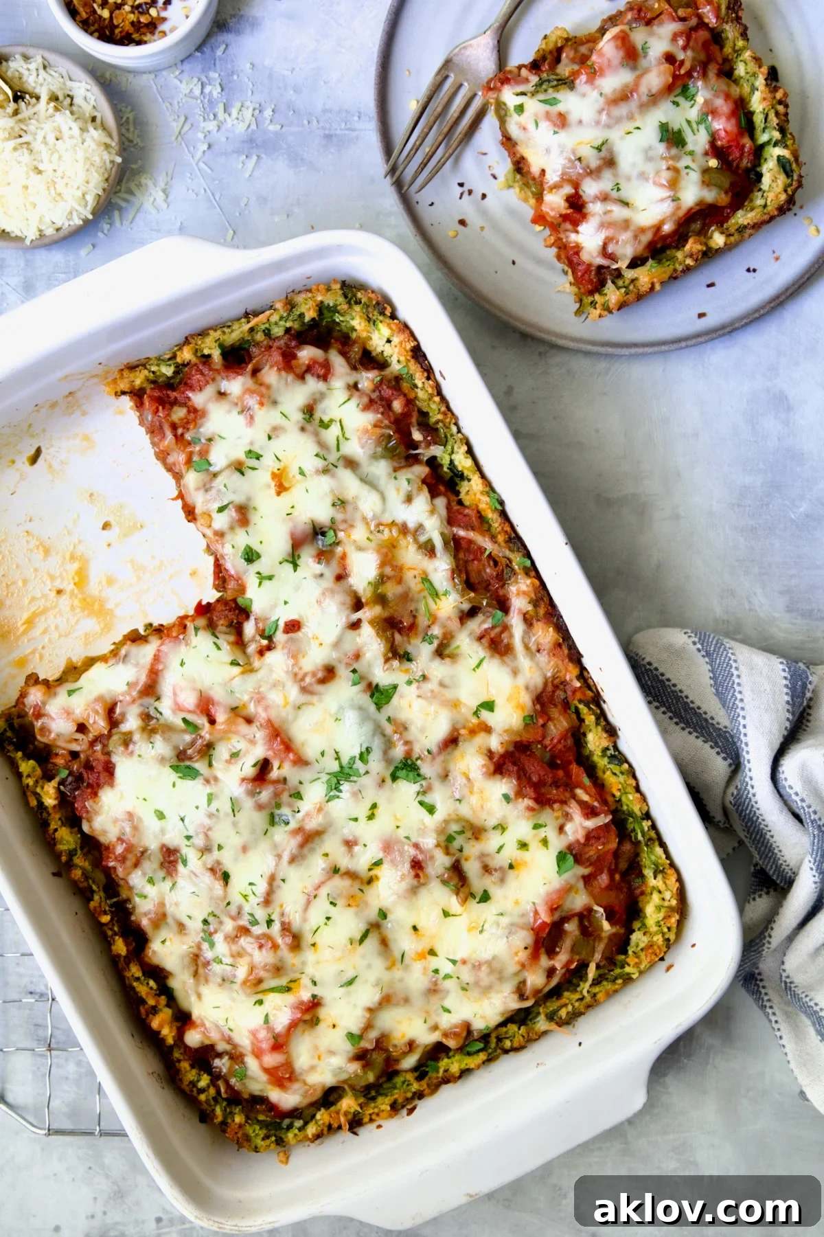 A piece cut from the Zucchini Pizza Casserole with it on a small round plate.