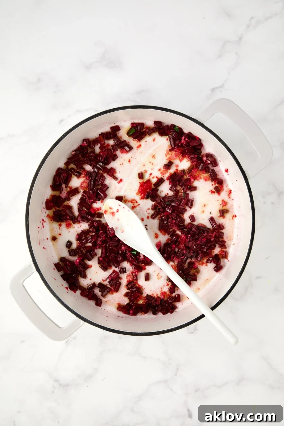 Sauteed beet stems in white enamel cast iron skillet.