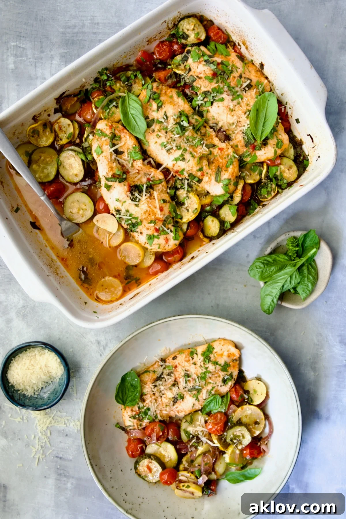 One-Pan Summer Vegetable and Chicken Bake with one serving removed to a plate.