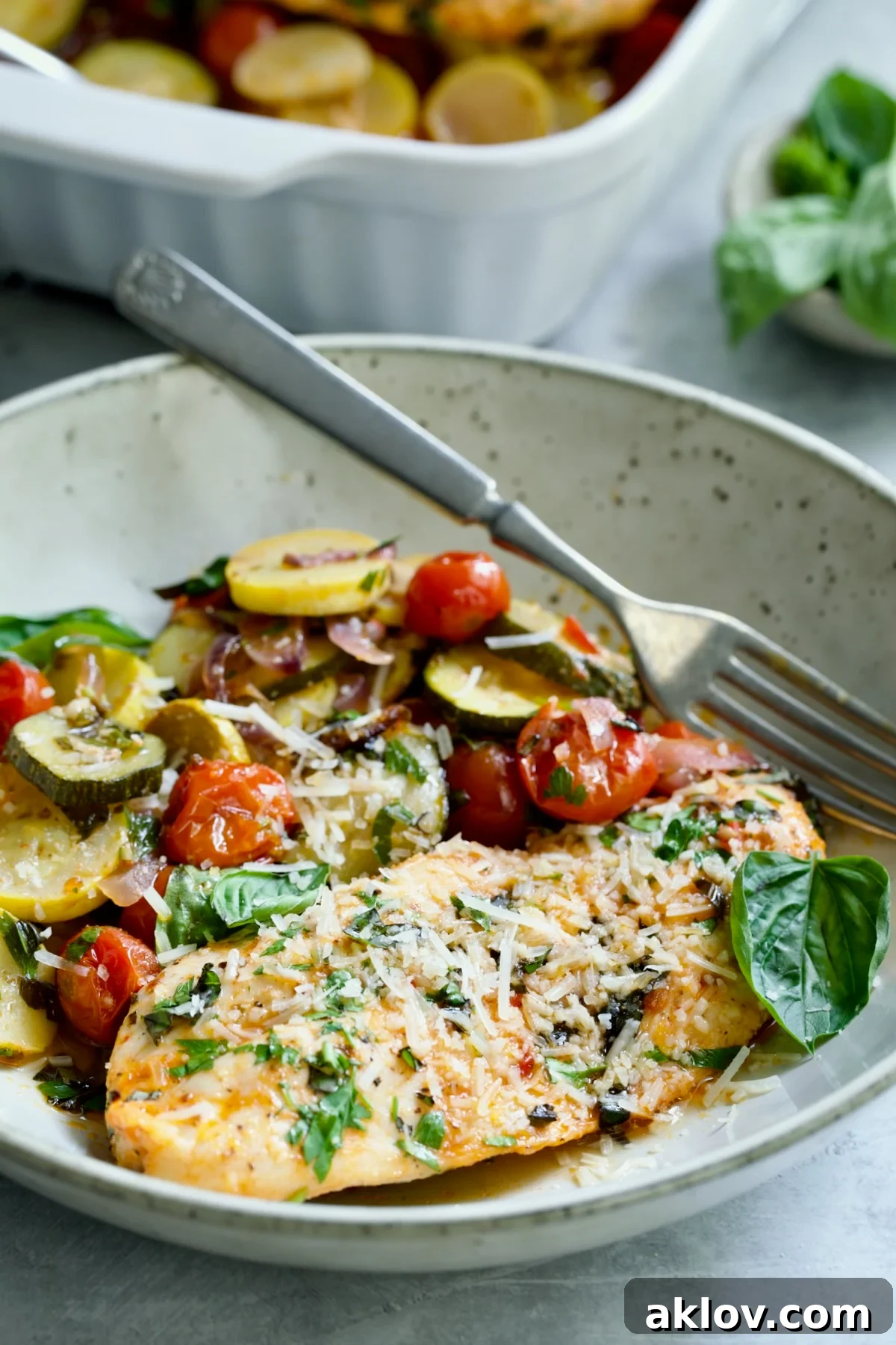 One serving of One-Pan Summer Vegetable and Chicken Bake in a bowl.