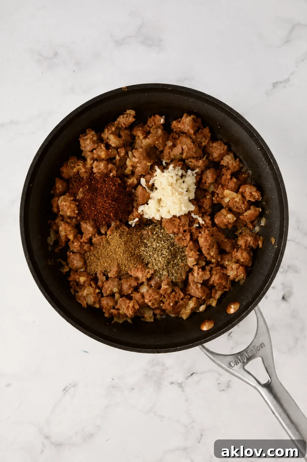Ground chorizo, garlic, chili powder, cumin and dried oregano in nonstick skillet.