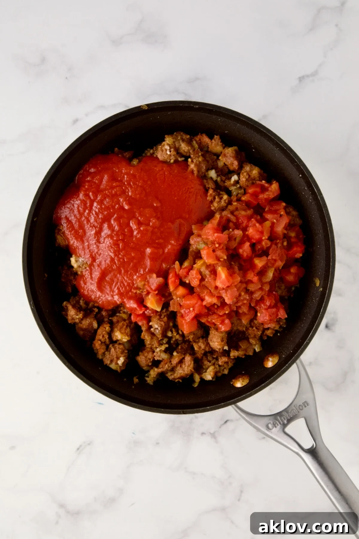 Cooked chorizo with tomato sauce, diced tomatoes and water added.